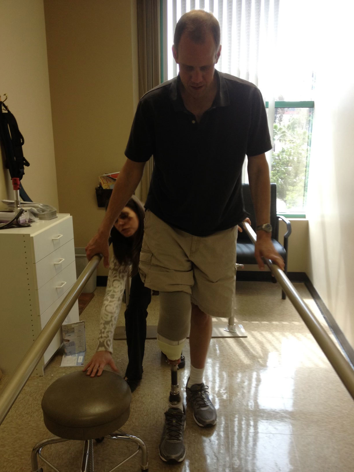 Doug Clark at a rehabilitation program practicing walking with his prosthetic leg.